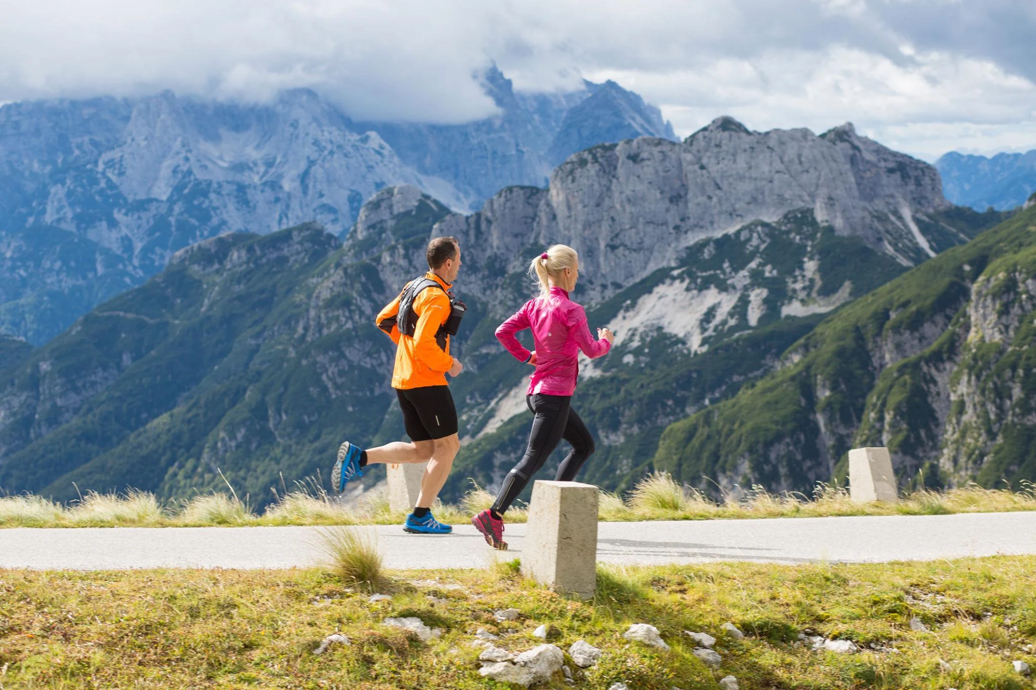 Two runners training on a mountain road